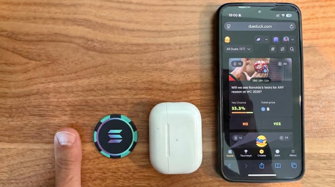The image shows a cell phone placed next to two other objects, including an earbud and an AirPods case. The cell phone displays a message that reads "only solana". This suggests that the person holding the phone might be interested in or using a cryptocurrency called Solana.