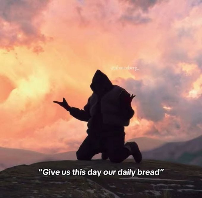 A silhouette of a hooded figure with a backpack kneels on a rocky peak against a pastel pink and orange cloudy sky, with the caption "'Give us this day our daily bread'" displayed below.