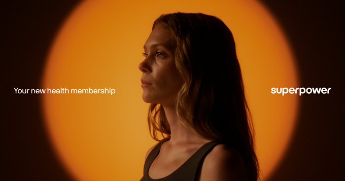 An advertisement with an orange circular backdrop featuring a woman in profile, with text reading 'Your new health membership' and the brand 'superpower' on the right.