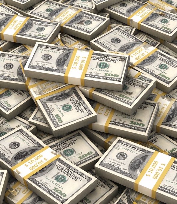 A large pile of US $100 bills bound in stacks of $10,000 with yellow currency straps.