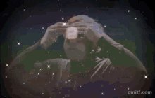 The image shows a person holding up their face with one hand, looking at an object that appears to be a small white box or cupcake. The background of the image features stars, giving the impression of being in outer space. There are also some text elements present in the image, including "pmiftcom" and "RLUSD", which could possibly be related to the post's context.