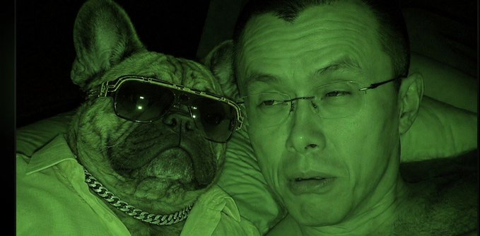 A man and a dog wearing sunglasses pose together, tinted entirely in green, in what appears to be a playful, surreal green-screen style photo. The accompanying post "@cz_binance" suggests the man is Changpeng Zhao, the founder of Binance, with the image likely created as a fun, AI-styled edit referencing his crypto platform.