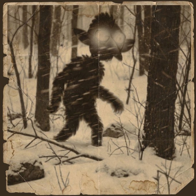 A weathered, sepia-toned vintage photograph depicting a dark, furry humanoid creature with large eyes standing in a snowy forest.