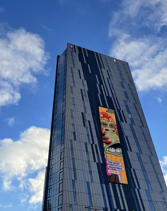 The image features a tall, gray building with an advertisement displayed on its side. The advertisement is for a movie called "Gran Torpedo", which has been shown at multiple ApeFest events around the world. The building's height and prominence in the scene suggest that it could be a significant landmark or a popular tourist attraction related to the movie.