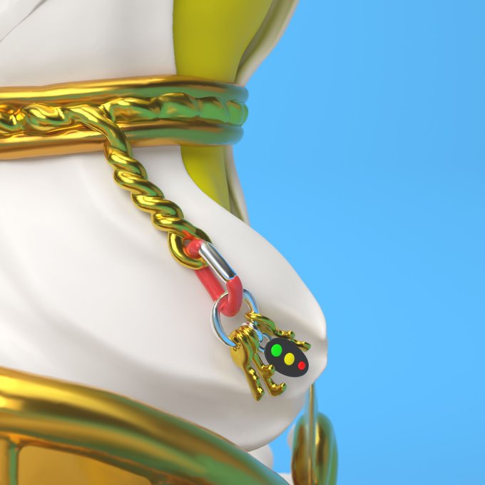A 3D rendered close-up shows a white glossy figure wearing gold chains and a red cord, with a small painter's palette keychain featuring green, yellow, and red dots, set against a bright blue background.