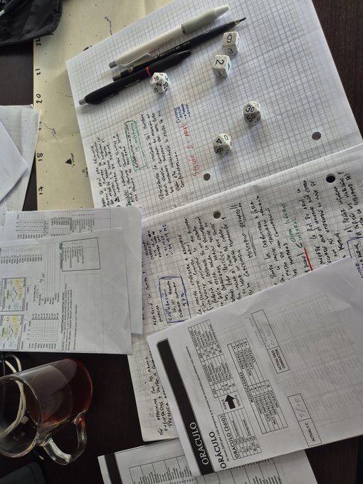 The image shows an open notebook with writing on it, along with several dice scattered around the page. There are also some papers and a cup of coffee placed nearby. The scene suggests that someone has been working on a project or studying for an exam using the notebook as their primary tool. The post about playing solitaire is related to this activity because it encourages people to take breaks from work or study by engaging in a relaxing game, which can help them recharge and refocus before returning to their tasks.
