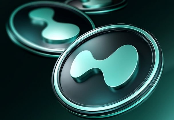 A 3D rendering of metallic coins or tokens featuring the Hyperliquid (HYPE) logo in teal/turquoise against a dark background.