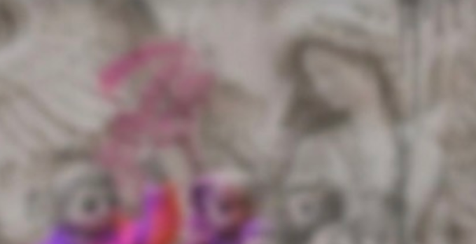 A heavily blurred, colorful image featuring pink, purple, and tan tones that appears to show a figure with vibrant hair, accompanying a post about the "Pythenians" NFT collection and its community of designers and creators. The visual content does not clearly display any readable text, numbers, or identifiable NFT artwork due to the heavy pixelation.