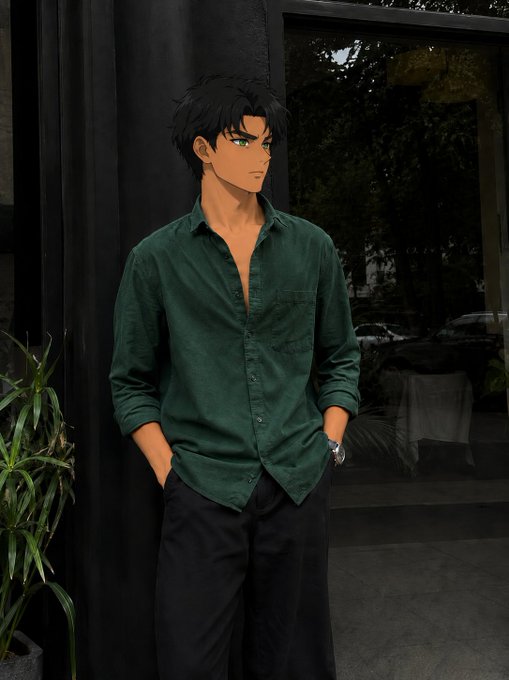 An anime-style illustration of a young man with messy black hair and green eyes, wearing a dark green button-up shirt and black pants, standing with his hands in his pockets.