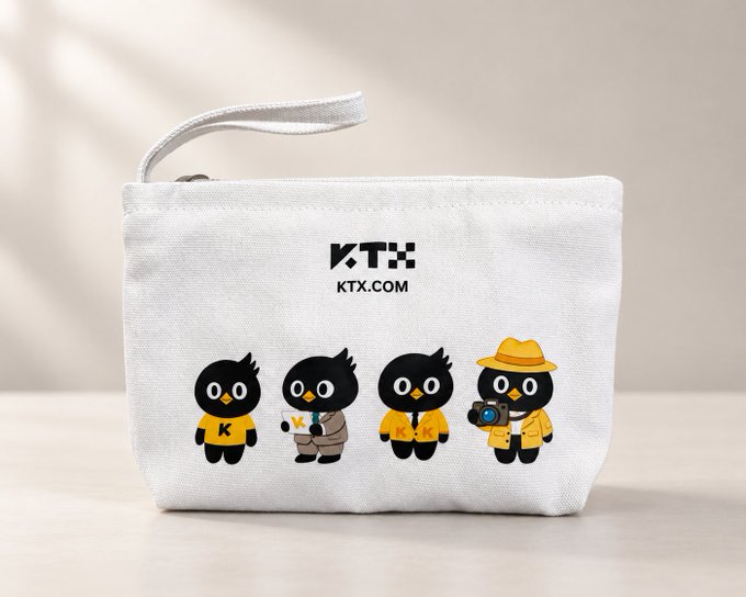 A white canvas pouch displays the 'KTX' logo with 'KTX.COM' text and features illustrations of four black cartoon bird characters in various yellow outfits, including a photographer with a yellow hat.