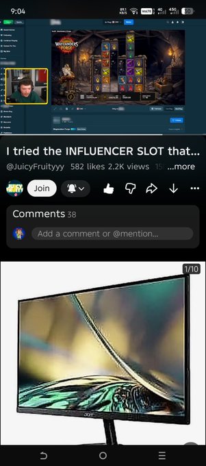 A mobile screenshot showing a YouTube video titled 'I tried the INFLUENCER SLOT...' by @JuicyFruityyy with 2.2K views, displaying a slot machine game and a curved monitor below.