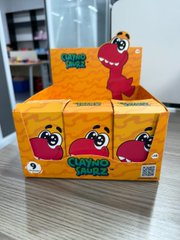 A display of orange toy boxes featuring a pink dinosaur character, branded 'GABBA DINOS' in what appears to be a retail store.