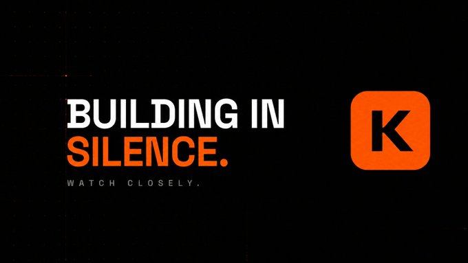 A dark promotional graphic with the text 'BUILDING IN SILENCE. WATCH CLOSELY.' next to an orange square containing the letter 'K'.