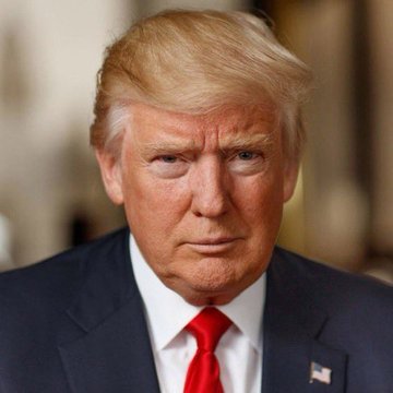 A man with blonde hair wearing a dark suit and red tie looks seriously toward the camera, with a small American flag pin visible on his lapel. The image accompanies news suggesting that he, identified in the post as Trump, may take executive action to purchase Bitcoin for a U.S. strategic reserve.