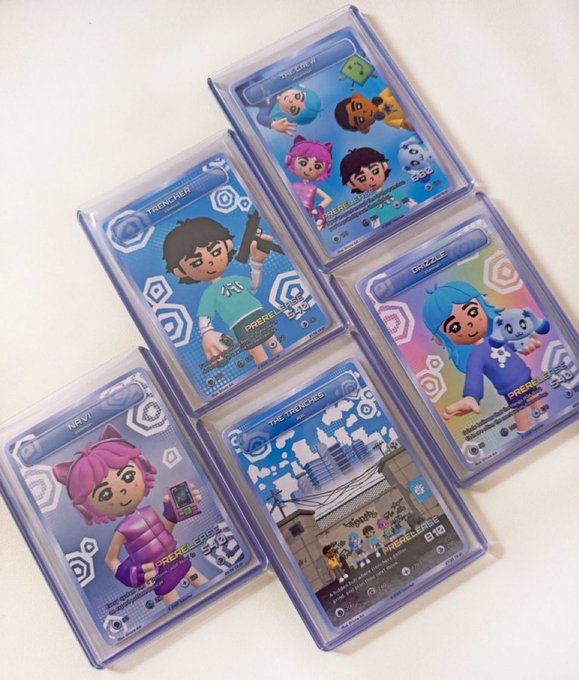 Six collectible trading cards in protective plastic sleeves featuring colorful cartoon-style characters with labels including 'THE CREW,' 'TRENCHEN,' 'GRIZZLE,' 'NAVI,' and 'THE TRENCHED,' marked with 'PREREL[EASE]' and 'BTRO' branding.