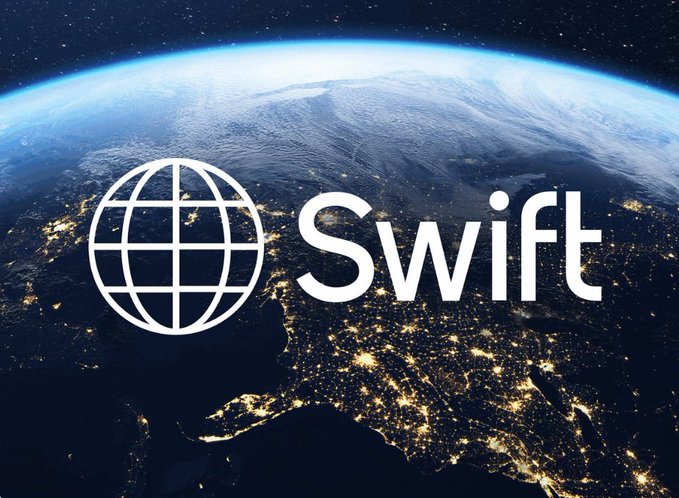 The Swift programming language logo, a globe design, is overlaid on a satellite view of Earth at night showing city lights across continents.
