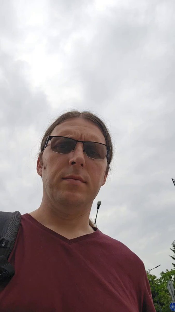 The image features a man wearing sunglasses, possibly posing for a photo or selfie. He has dark hair and is dressed in a maroon shirt. There are no other people visible in the frame, which emphasizes the subject of the picture. The background appears to be a cloudy sky, adding an interesting visual element to the scene. The image also contains text that reads "Don't give up, I see your pain on the timeline. Ghost town it is but the best cooks are found when no one is watching like: $XONA #M87 $OBX $HYRE $DEEPAI $SPECTRE #UPSCALP $NOCK $HATCHER $SANA And many more." This text seems to be related to a post or social media account, possibly discussing the challenges of cooking in a ghost town.
