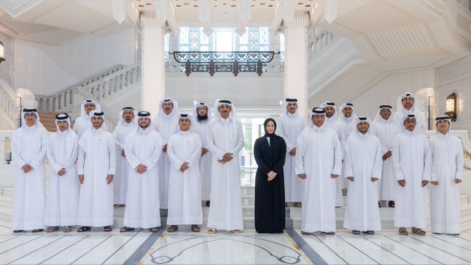 A formal group photo of men in traditional white thobes and a woman in a black abaya pose in a grand white marble hall, appearing to be a corporate or institutional gathering. The image accompanies a post about SidraChain's ecosystem development, lending a sense of official endorsement and seriousness to the announcement about the platform's transition toward transparency and execution.