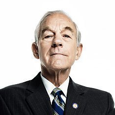 Former U.S. Congressman Ron Paul, wearing a dark suit with a striped blue tie and congressional pin, looks directly at the camera against a white background, aligning with his statement advocating for Bitcoin's legalization as legal tender to compete with the U.S. Dollar.