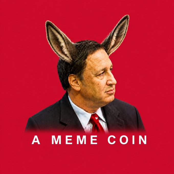 A meme-style portrait of a suited man wearing donkey ears against a red background, with the caption “A MEME COIN.”