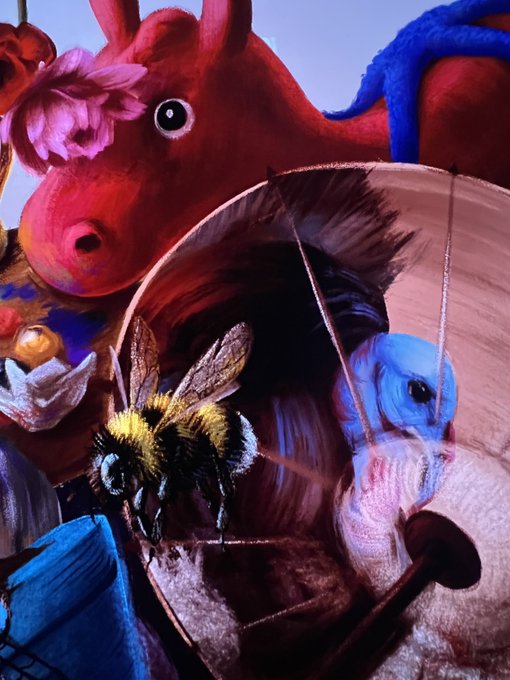 A colorful scene featuring a large red plush horse with a pink flower, a detailed bee in mid-flight, and a blue-haired stuffed animal peeking out from inside a hat.