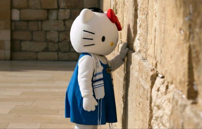 A Hello Kitty mascot wearing a blue dress places a small note between the stones of an ancient wall, appearing to slip it into the Western Wall—evoking the post's reference to a surprise "$KITTY" pump, playing on the crypto token's mascot-themed name.