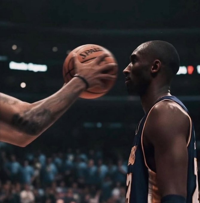 A basketball player in a dark blue jersey stands intensely focused as a tattooed opponent holds a basketball inches from his face, the word "SPALDING" visible on the ball. The image's theme of defensive preparation and facing an incoming threat mirrors Starknet's positioning as a "bet on post-quantum security"—standing ready to withstand a looming cryptographic challenge before it arrives.