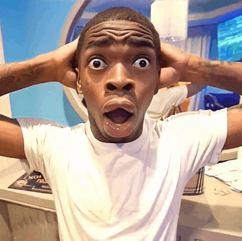 A young man in a white t-shirt stands with both hands clutching his head and his mouth agape in an expression of shock or disbelief, captured in what appears to be a bathroom with blue walls and a round mirror behind him. The image's exaggerated look of stunned realization perfectly captures the post's sentiment of disbelief that many current onchain traders are unfamiliar with Friend.tech, the earlier social finance app.