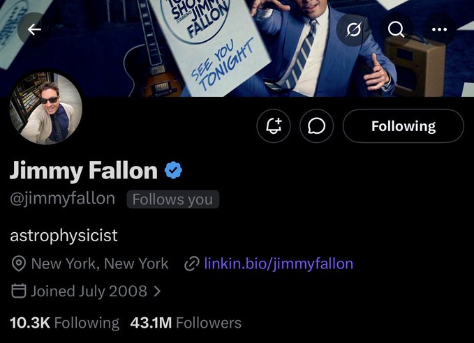 The image features a man wearing a suit, standing next to a guitar. He appears to be posing for a photo or video. Below him, there's a Twitter account with a profile picture of the man and his name displayed at the top. The account has been mentioned by several people, including the hashtag #BoredApeYachtClub. This indicates that the man might have an interest in boats or sailing, as suggested by the post.