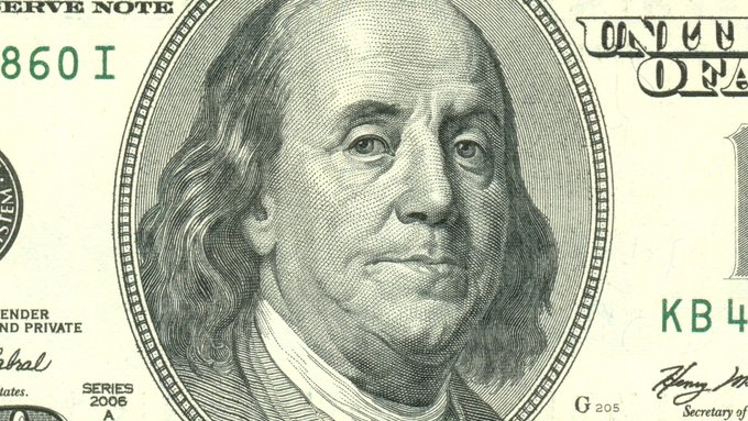 A close-up of a US one hundred dollar bill featuring the engraved portrait of Benjamin Franklin, with 'SERIES 2006' visible at the bottom.