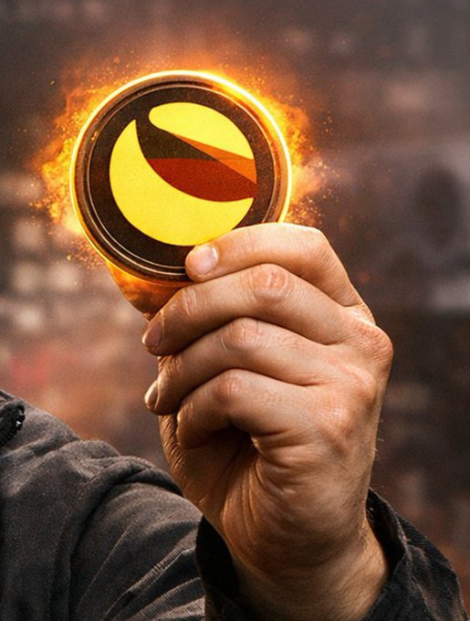 A hand triumphantly grips a glowing $LUNC (Terra Luna Classic) coin engulfed in flames against a blurred background, symbolizing the token's fiery momentum and verified +20% year-to-date gain despite recent short-term volatility.
