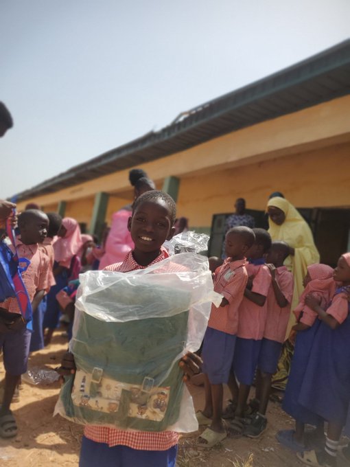 A child proudly holds a new backpack, symbolizing hope and opportunity for education in this image that illustrates the mission mentioned in the accompanying post about supporting children's futures. The post also lists EVM and cryptocurrencies like BNB, ETH, USDT, USDC, and CRO as donation options.