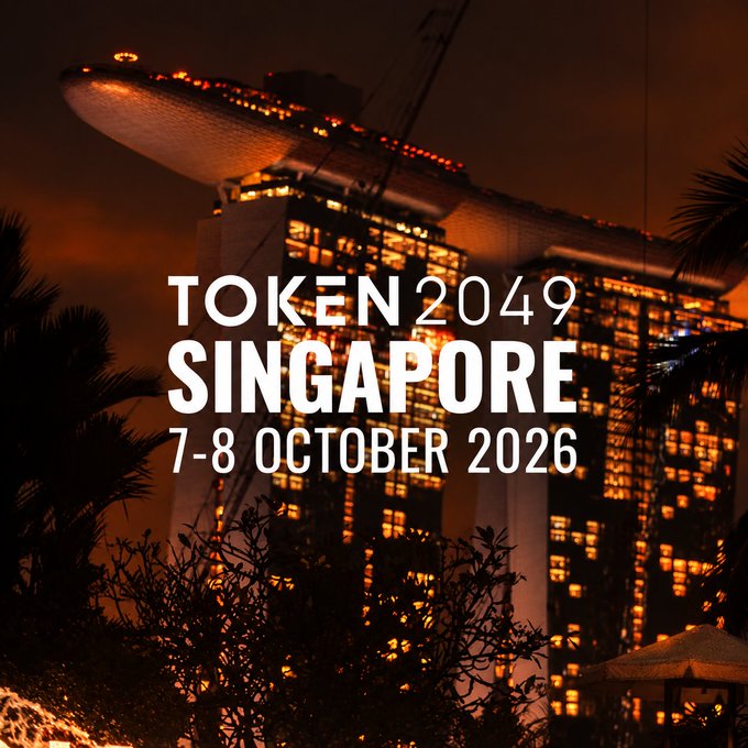 A promotional image for 'TOKEN 2049 SINGAPORE' on '7-8 OCTOBER 2026,' set against a nighttime cityscape featuring the Marina Bay Sands hotel.