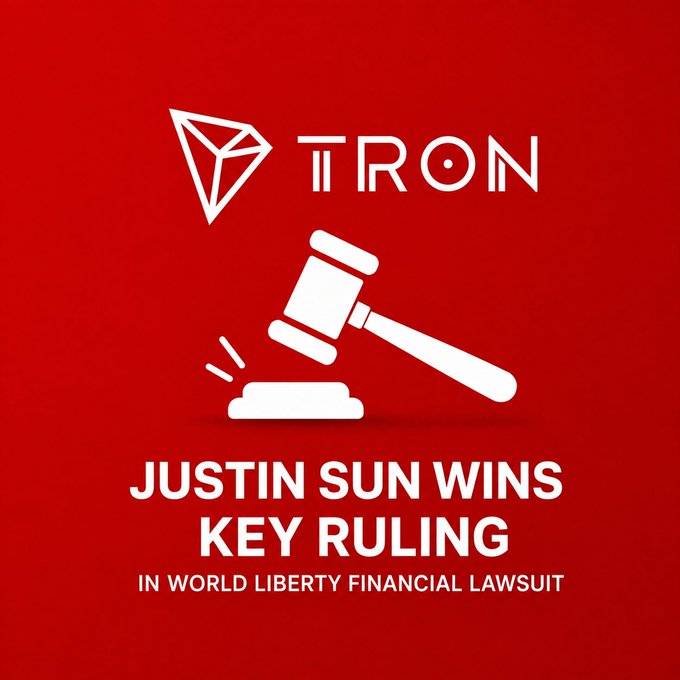 A graphic on a red background featuring the TRON logo at the top, a white gavel striking a sound block in the center, and the bold text "JUSTIN SUN WINS KEY RULING IN WORLD LIBERTY FINANCIAL LAWSUIT" at the bottom, visually reinforcing the post's announcement that a federal judge ruled in Justin Sun's favor against World Liberty Financial's attempt to move the case to private arbitration.