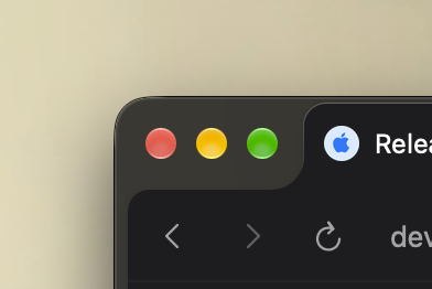 A close-up of a dark-themed browser window corner showing the macOS traffic light buttons (red, yellow, green), a Safari reload button, and an Apple logo with the text 'Relea'.
