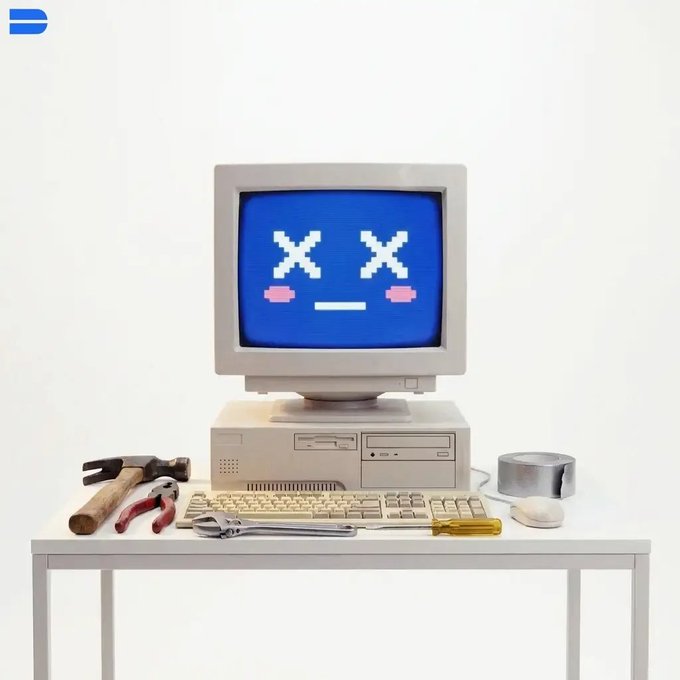 A vintage CRT monitor displays a pixelated 'dead' face with X eyes and pink cheeks, sitting atop a desktop computer tower with a hammer, pliers, and screwdriver arranged on the desk.
