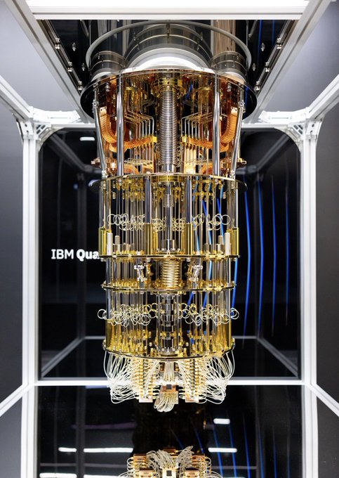 The image shows IBM's quantum computer, visible from the text "IBM Qua..." on its glass casing, displaying its intricate gold-hued chandelier-like processor suspended within a cylindrical cooling apparatus. This relates directly to the post's warning that Zcash ($ZEC) is now quantum recoverable following its migration to Ironwood, making it vulnerable to the advancing capabilities of machines like this one, rather than being driven by privacy-focused demand alone.