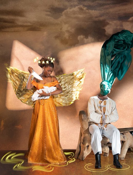 A surreal composition shows a woman in an orange gown with golden wings cradling a baby, while a seated figure wears a green covering over their head; a large painted play button appears on the backdrop.