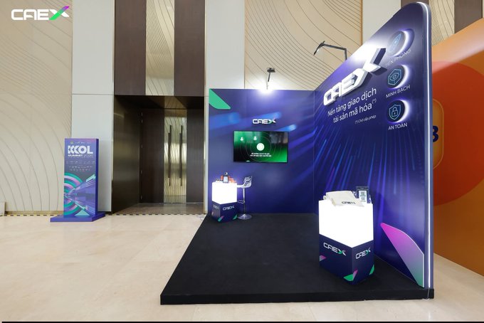 A modern exhibition booth display for 'CREX' features digital screens, branded signage, and product displays in a corporate setting.