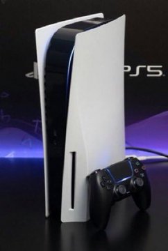 A Sony PlayStation 5 console with a DualSense controller displayed in front of its box against a dark background with purple lighting, with the 'PS5' logo visible.
