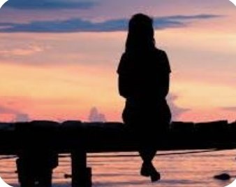 A silhouette of a person sits on a ledge gazing at a vibrant sunset over water, with their reflection visible below. The tranquil, reflective scene complements a "goodnight" message, capturing a quiet, contemplative end-of-day moment.