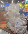 A white ice sculpture, possibly depicting an animal, sits in a glass container surrounded by crushed ice, likely at a restaurant.