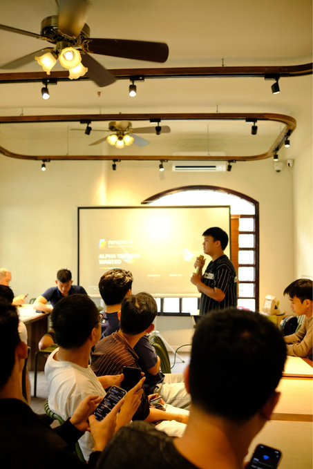 A speaker with the title "Regional Ambassador" stands before a presentation screen displaying "ALPHA VERSE HACKATHON" while addressing an attentive audience at the Renaiss Vietnam Meetup. The scene captures a room of engaged participants, including someone recording the event on their phone, reflecting the enthusiastic community support mentioned in the post.