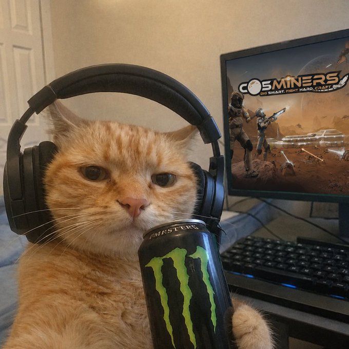 An orange cat wearing black gaming headphones sits in front of a monitor displaying the game "Cosminers," holding a can of Monster energy drink next to a glowing keyboard.