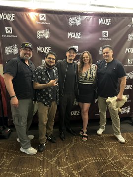 A group of five people pose together on a red carpet in front of a "Mouse" film premiere backdrop with Film Solutions and Reel Abilities logos, celebrating the event with the MetaverseLyfe team and VeVe community as referenced in the post.