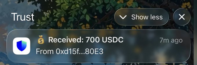 A Trust wallet notification showing 'Received: 700 USDC' from address 0xd15f...80E3, received 7 minutes ago, with a 'Show less' button visible.
