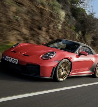 A red Porsche 911 GT3 with license plate "S GT 3992" speeds along a mountain road, illustrating the post's claim about Porsche dealerships in France now accepting Bitcoin and cryptocurrency as payment, positioning BTC as a global standard for luxury purchases.