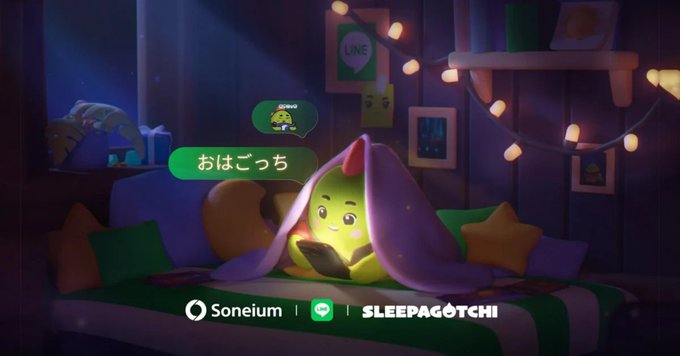 A cozy 3D animation scene featuring a cute yellow creature tucked under a blanket on a bed reading a phone, with the text 'おはごっち' in a speech bubble and 'Soneium | SLEEPAGOTCHI' logos at the bottom.