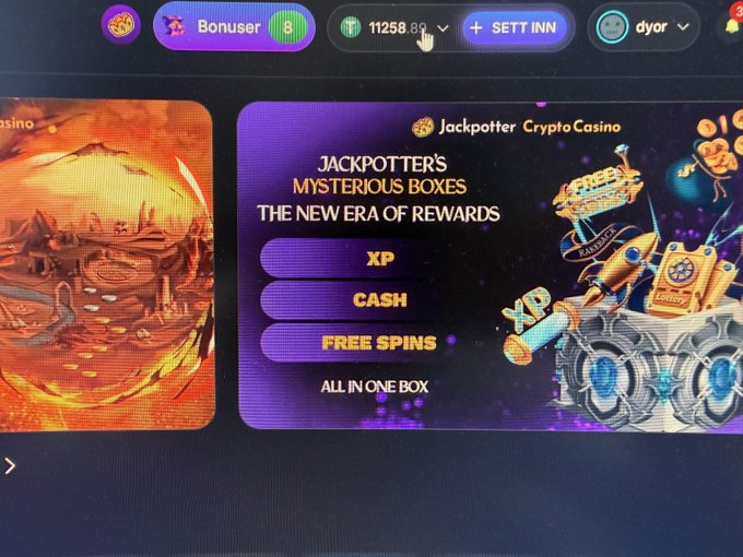 A screenshot of an online casino website promoting 'Jackpotter Crypto Casino' and 'Jackpotter's Mysterious Boxes' featuring XP, CASH, and FREE SPINS rewards. The interface shows a user profile 'Bonuser' with a balance of 11258.89.