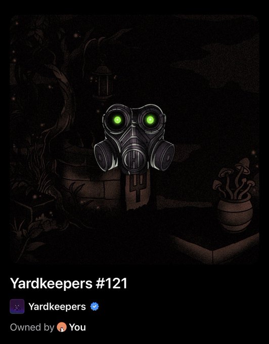 A dark, atmospheric digital artwork titled 'Yardkeepers #121' by Yardkeepers showing a stone totem or sculpture with glowing green eyes in a dimly lit garden setting with a lantern, plants, and mushrooms.